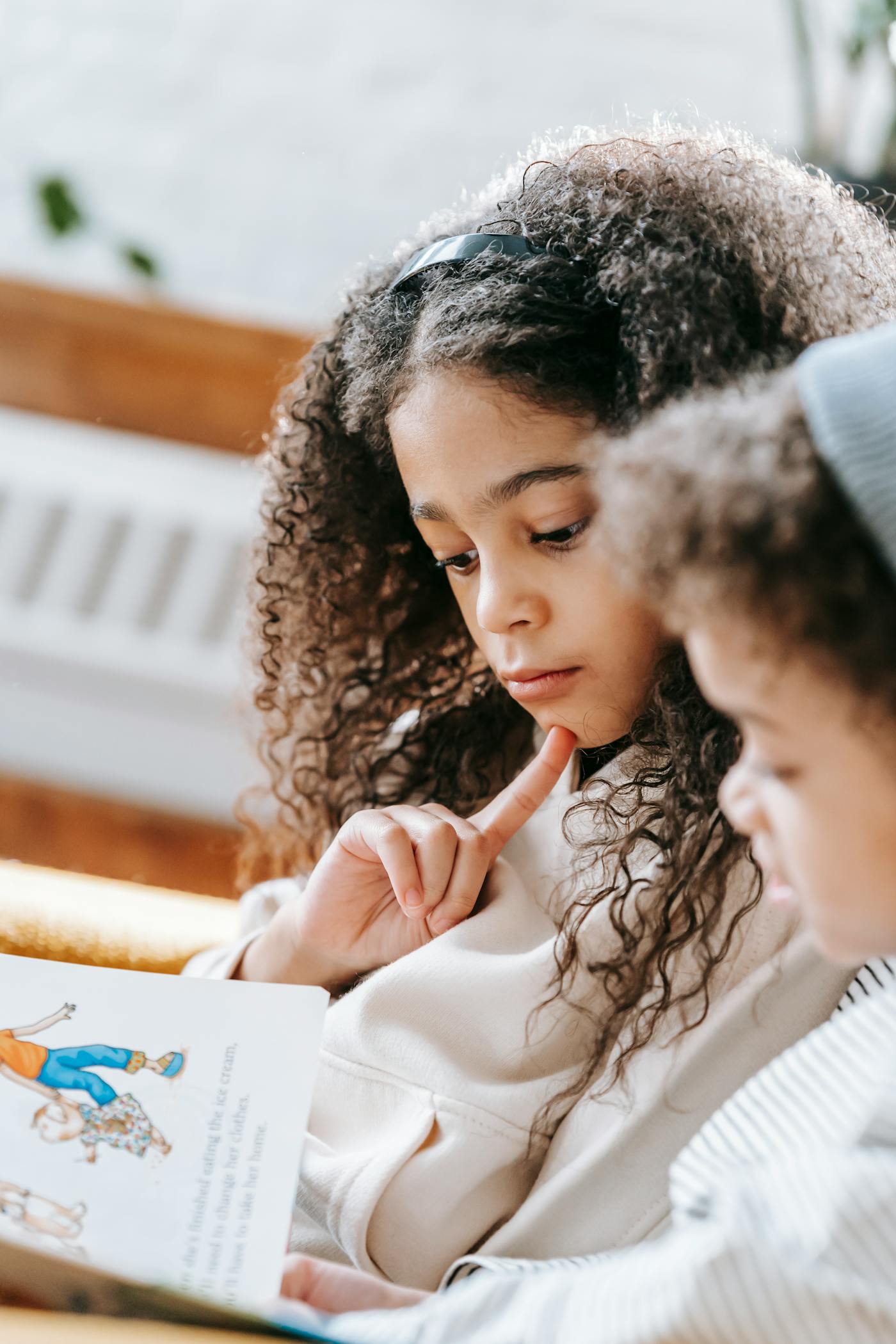 Young child reading peacefully in a cozy home setting
