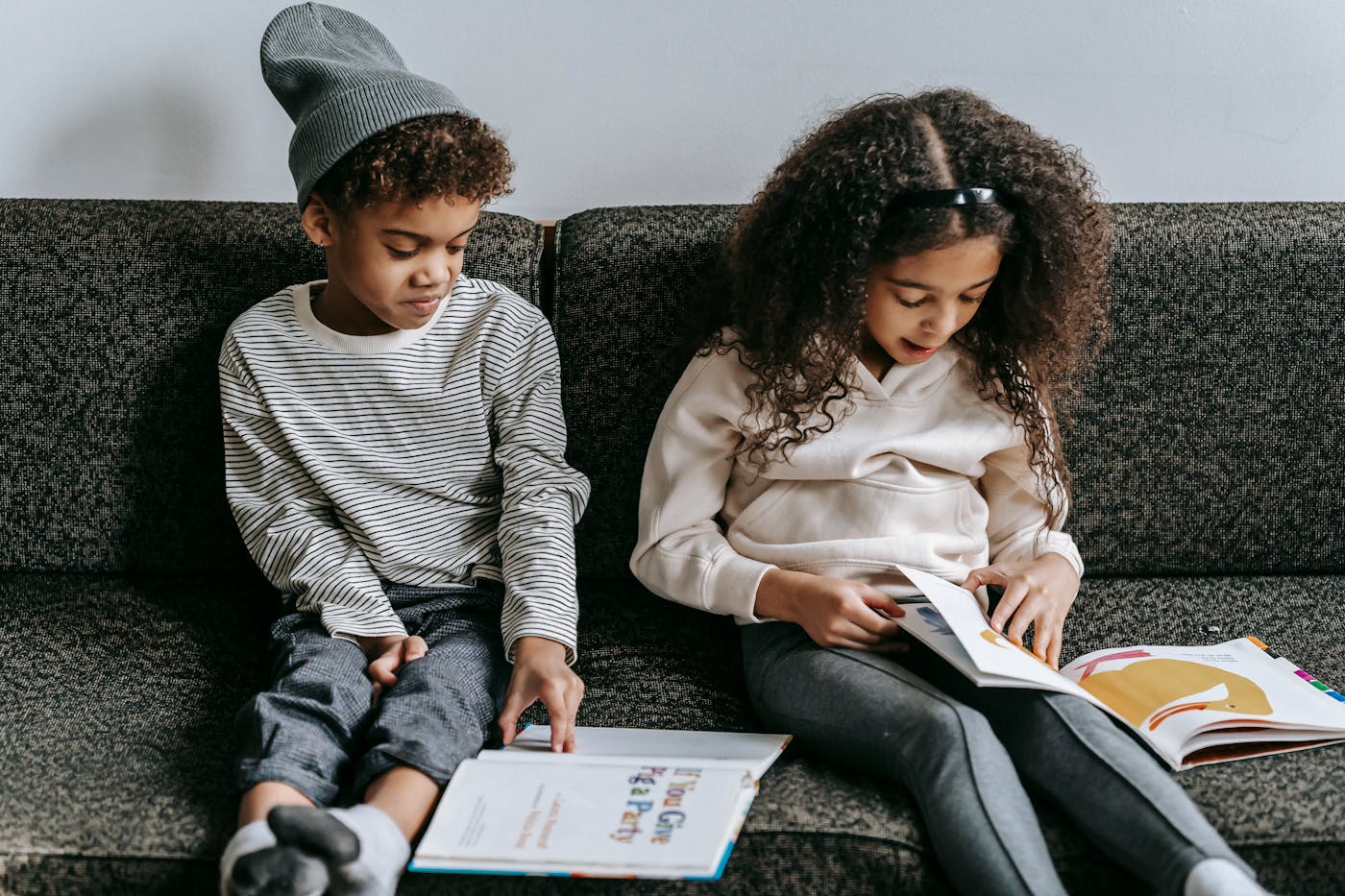 Child in a cozy reading setting with warm lighting