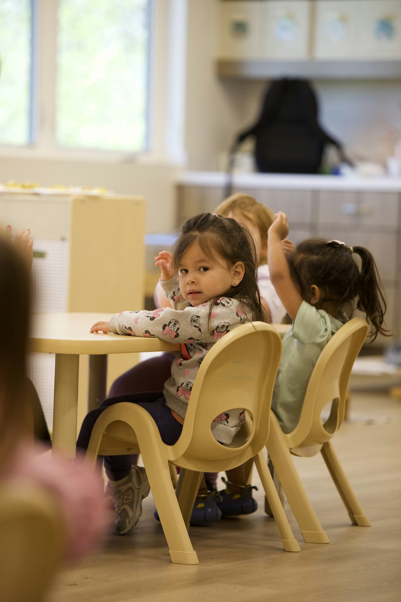 Small group of toddlers learning together at a table